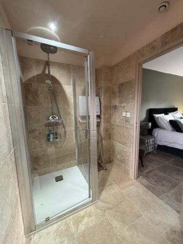 a shower with a glass door in a bathroom at Villa Rosalia in Uzès