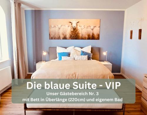 a bedroom with a bed with a painting of a cow at Lounge94 - Luxus auf 180 m2 in Wilhelmshaven