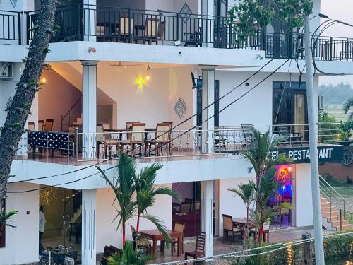 a view of a building with tables and chairs at Tissa Yala Lake View Hotel in Tissamaharama