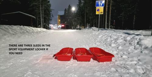 a pair of red shoes in the snow at LEVI Tunturinlaita A4, Ski-in Ski-out 3xBedroom in Levi