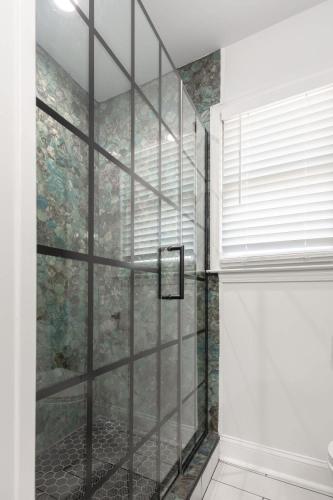 a shower with a glass door in a bathroom at Big Modern Family Home On 1 Acre Land w Firepit & Grill in Ellenwood