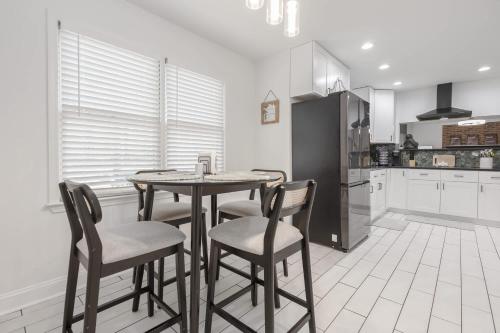 a kitchen with a table and chairs in a room at Big Modern Family Home On 1 Acre Land w Firepit & Grill in Ellenwood