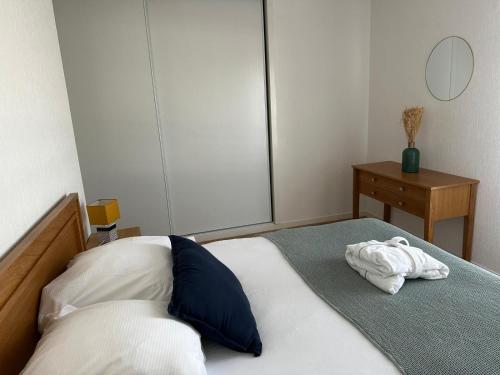 a bedroom with a bed with a towel on it at Domitys Le Chant des Lavandières in Vernouillet