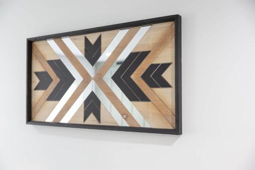 a framed picture of a geometric design on a wall at Big Modern Family Home On 1 Acre Land w Firepit & Grill in Ellenwood
