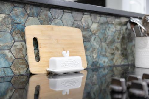 a wooden bird house on a counter in front of a wall at Big Modern Family Home On 1 Acre Land w Firepit & Grill in Ellenwood
