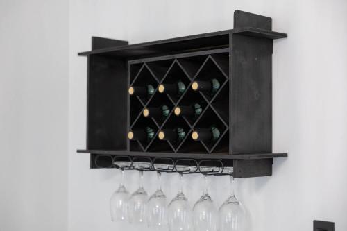 a black wine rack with wine glasses in it at Big Modern Family Home On 1 Acre Land w Firepit & Grill in Ellenwood