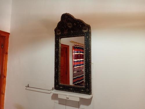 a mirror on a wall on a wall at Hotel Source De Dades in Boumalne