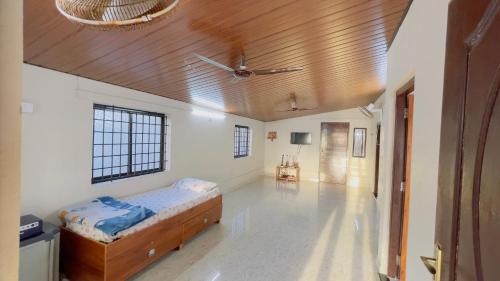 a bedroom with a bed and a wooden ceiling at Sea Shells by Malpe - Udupi in Cocoanut Island