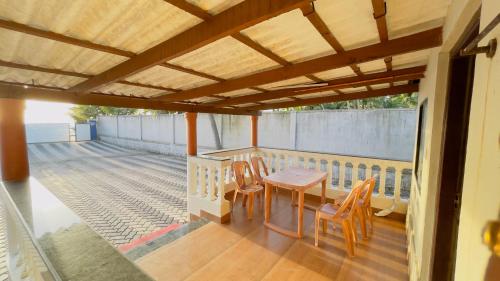 a patio with a table and chairs on a balcony at Sea Shells by Malpe - Udupi in Cocoanut Island