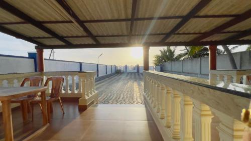 a balcony with a table and chairs on a building at Sea Shells by Malpe - Udupi in Cocoanut Island