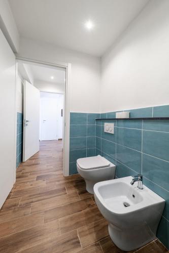 a bathroom with two toilets and a sink at Giano Host - Gozzano, Simple Pleasures in Genova