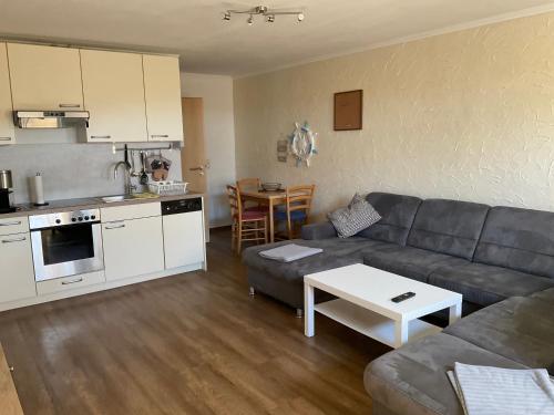 a living room with a couch and a table at Rügen Fewo 306 in Berglase
