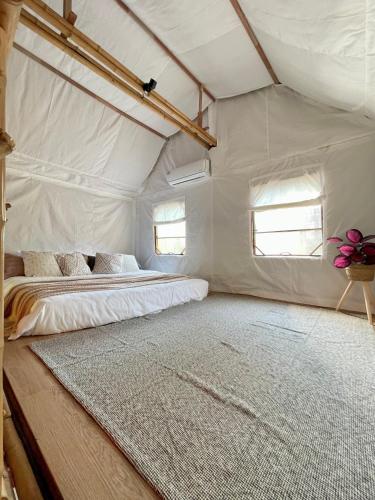 a bedroom with a bed in a tent at Vimala Bamboo #1, Villa with Private Jacuzzi Pool in Hua Hin