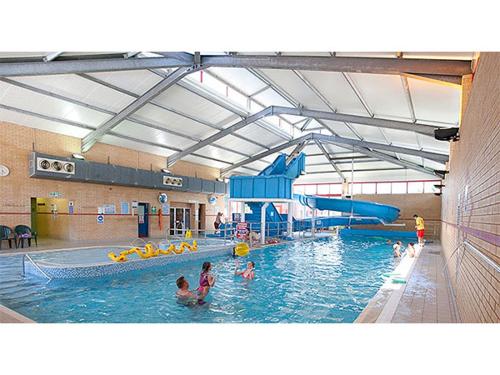 a large swimming pool with people in the water at Jasmine Corner - entertainment passes included - message for longer stays in Ringwood