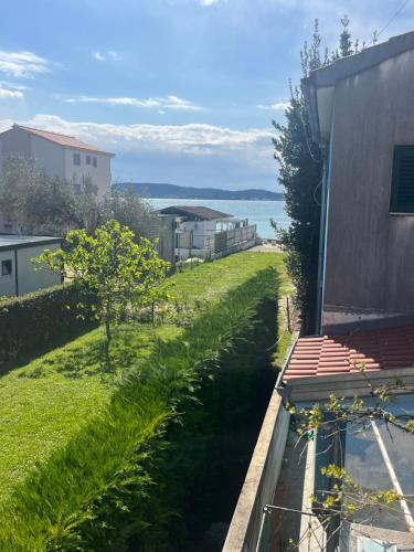 a view from the balcony of a house with a yard at Captains Cove in Sukošan