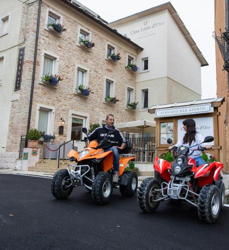 a man and a woman riding on four wheelers at Casa Leon d'Oro in Bosco Chiesanuova
