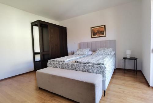 a bedroom with two beds and a ottoman at Casa Sol Maris in Novigrad Istria