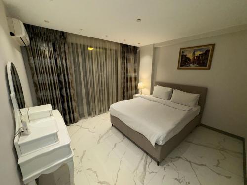 a hotel room with a bed and a sink at CTS Elysium Residence Taksim in Istanbul