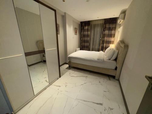 a bedroom with a mirror and a bed in a room at CTS Elysium Residence Taksim in Istanbul