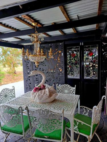 a dining room table with a swan on a wall at Bettys Mountain Cottage in York