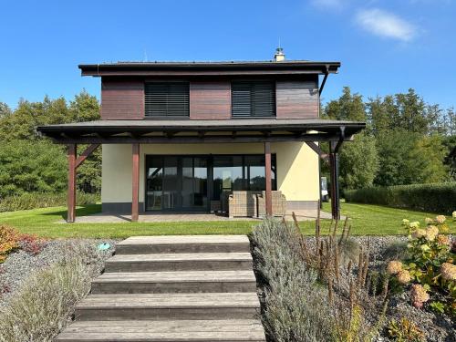 a house with a staircase in front of it at Lake House 513 in Šajdíkove Humence