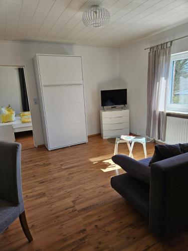 a living room with a couch and a tv at Bokelrehm 4 in Bokelrehm