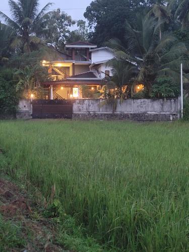 a house in the middle of a field at Sampatha Southern Villa & Restaurant & Cooking class -Talalla in Talalla