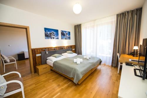 Postel nebo postele na pokoji v ubytování Resort Líšenský Dvůr