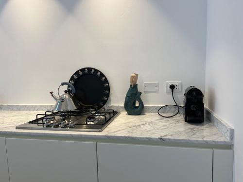 a kitchen counter with a pot on a stove at Casa MauRo in Senigallia