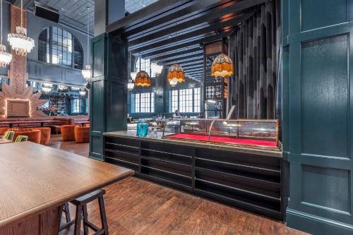 a dining room with a sink and a table at Hotel Indigo Nashville - The Countrypolitan in Nashville