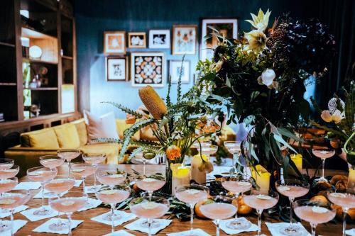 a table with wine glasses and flowers on it at Hotel Indigo Nashville - The Countrypolitan in Nashville