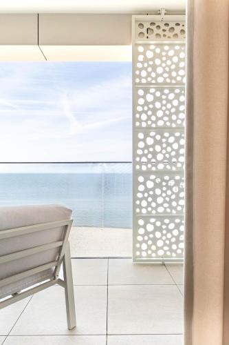 a room with a bench and a view of the ocean at RJ Apartament Baltic Infinity Resort & Spa - free parking in Międzyzdroje