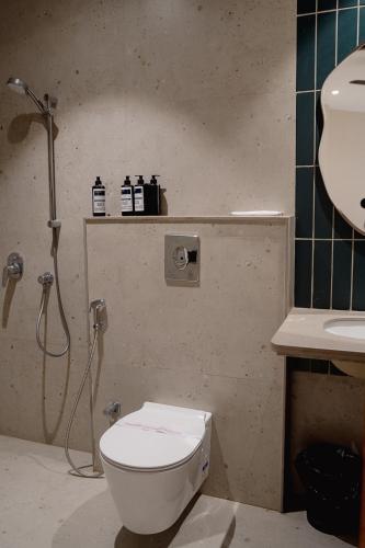 a bathroom with a toilet and a shower and a sink at Kaas by Safarnama - Boutique Hotel in Varanasi