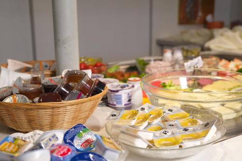 a table with bowls of food and baskets of food at Vivotel Niederrhein in Voerde