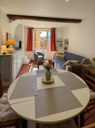 un salon avec une table et un canapé dans l'établissement La petite maison, à Noyers-sur-Serein