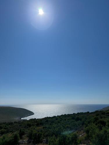 a view of the ocean with the sun in the sky at Koukouri Village in Kafióna