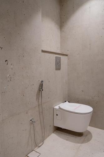 a bathroom with a toilet and a shower at Kaas by Safarnama - Boutique Hotel in Varanasi