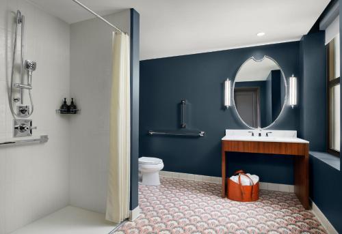 a bathroom with a sink and a mirror at Hotel Indigo Nashville - The Countrypolitan in Nashville