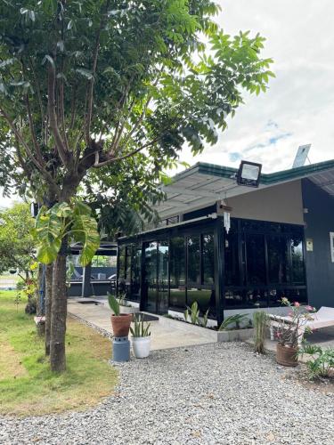 a building with a tree in front of it at The MIAGE Resthouse in Baliuag