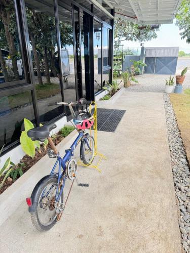 a bike parked on a sidewalk next to a building at The MIAGE Resthouse in Baliuag