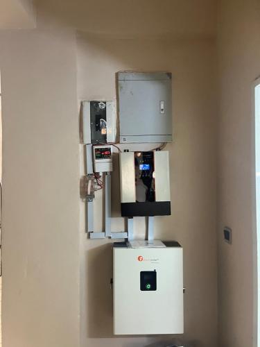 a machine on a wall in a room at The cozy spot by Jules - 1 bedroom in Katampe in Mobushipe