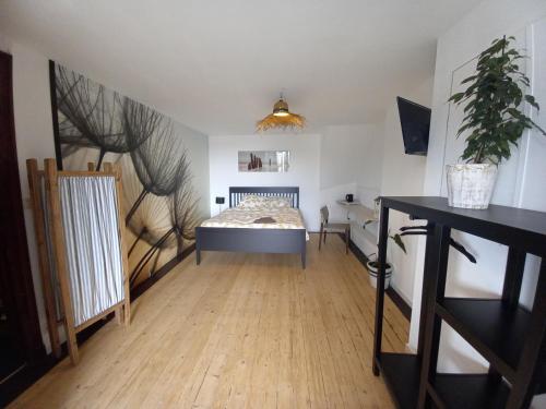 a bedroom with a bed and a wooden floor at Villa Stella Maris in Ostend