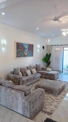 a large living room with couches in a room at Kay's Residence in Mombasa
