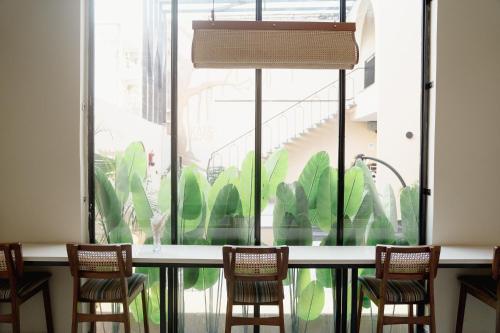 a group of chairs sitting in front of a window at Kaas by Safarnama - Boutique Hotel in Varanasi