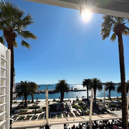 a view of a beach with palm trees and the ocean at Guest House Imperial in Split