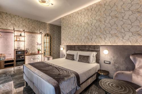 a hotel room with a bed and a chair at Apollo Boutique Hotel in Rome