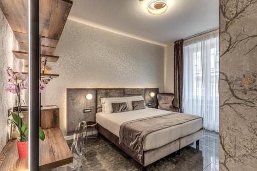a hotel room with a bed and a window at Apollo Boutique Hotel in Rome