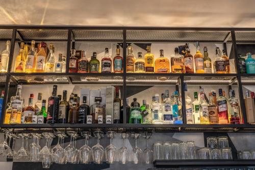 a bar filled with lots of bottles and glasses at Apollo Boutique Hotel in Rome