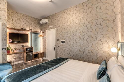 a bedroom with a bed and a wall with wallpaper at Apollo Boutique Hotel in Rome