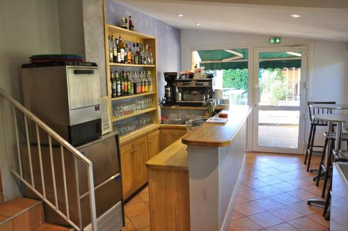 a kitchen with a counter and a bar with a stove at Le Provence in Manosque